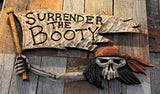 Decorative wall art with a skull and spear on a wooden background